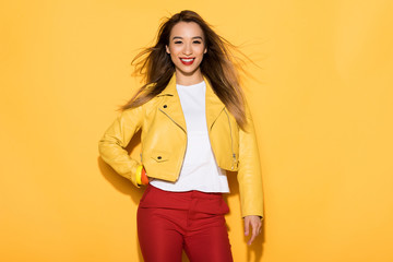 young asian female model posing on yellow background