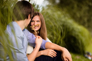 Young man and woman having fun in park