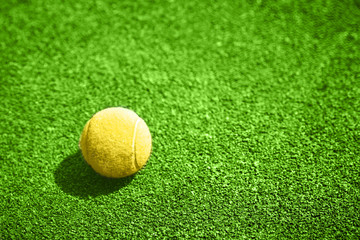 Closeup of a yellow tennis ball.