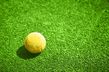 Closeup of a yellow tennis ball.