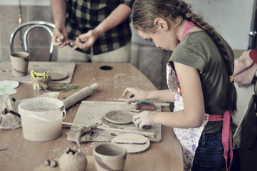 Fototapeta na wymiar Girl learning to work with clay.