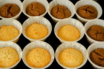 cupcakes without the filling are almost ready, the ingredients are mixed for cake, flour, cocoa and sugar are poured into a bowl for making cupcakes