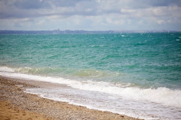 Sea shore with turquoise water and fine yellow sand