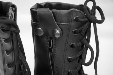 military boots black on the lock and with rivets, sole with a pattern, legs for protection of legs