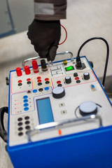 Electrician engineer tests system with relay test set equipment