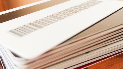 a pile of credit and discount cards with a barcode