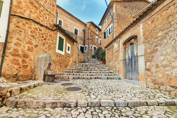 Fornalutx village cobbled street stairs and stone houses, mediterranean typical architecture in Balearic Islands
