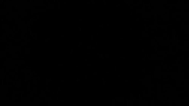 Close up of the hand holds an inflamed lighter on a black background