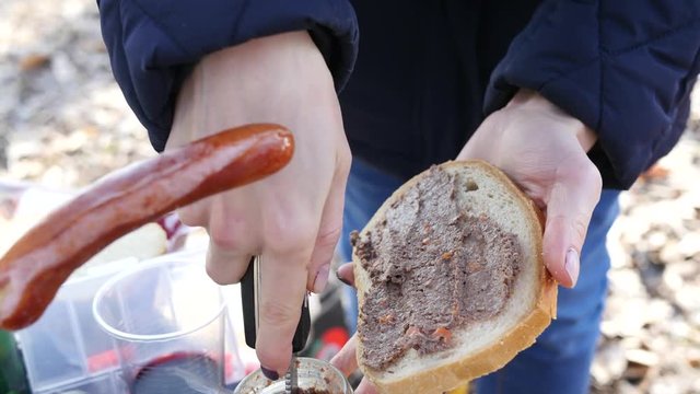 Make a sandwich with pate on nature, family picnic