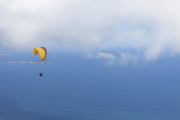 Paraglider flying over Sao Conrado in Rio de Janeiro.