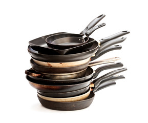 Stack  of used frying pans isolated on white © lena_zajchikova