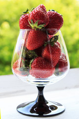 Fresh strawberries in a glass goblet. Dessert made from fresh strawberries. Selective focus.