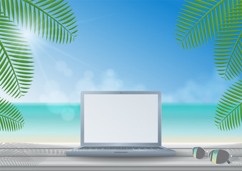 Laptop computer on front view with sunglasses on wooden desk in a sunny day under coconut trees shade on the beach, sea, clouds and clear blue sky background