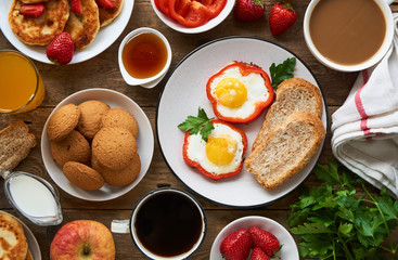 Various breakfast dishes on a wooden table 