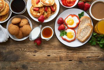 Various breakfast dishes on a wooden table 