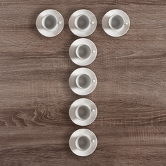 Alphabet letter T made of empty coffee cups