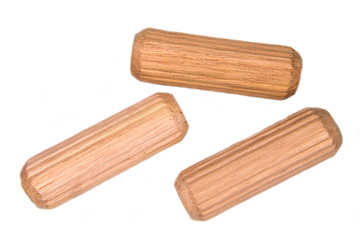 Carpenter wood pegs on a white background viewed from above