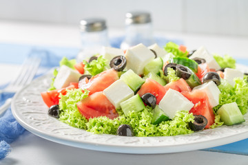 Delicious Greek salad with black olives, feta cheese and lettuce