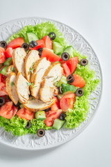 Tasty Caesar salad with chicken, olives and tomatoes