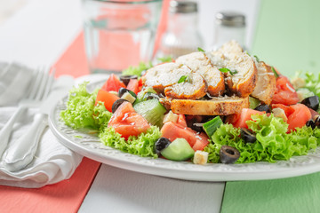 Healthy Caesar salad with olives, tomatoes and lettuce