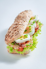 Tasty sandwich with eggs, bacon and lettuce