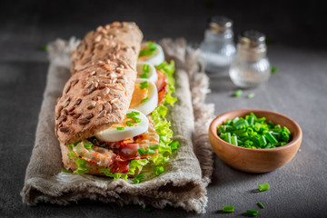 Homemade sandwich with bacon, eggs and chive