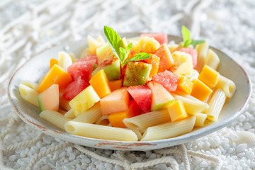 Tasty penne with melon, pineapple and papaya