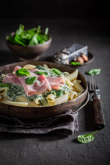 Delicious pasta with bechamel sauce, ham and spinach