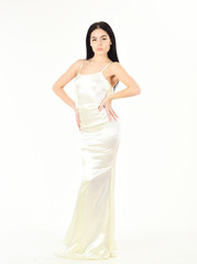 Slim and fit concept. Lady on calm face wears expensive fashionable evening dress. Fashion model with slim figure as result of dieting and fitness. Woman in elegant white dress, white background.