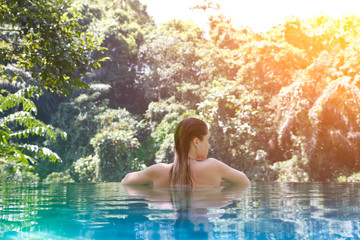 girl in the tropic jungle pool