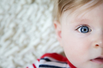 Adorable baby with blue eyes, natural light portrait