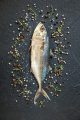 Fresh, raw mackerel on a black background.
