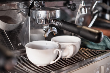 Coffee Maker making coffee flowing in cup