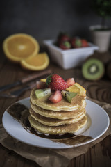Buckwheat pancakes with berry fruit and honey.