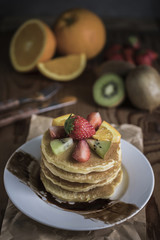 Buckwheat pancakes with berry fruit and honey.