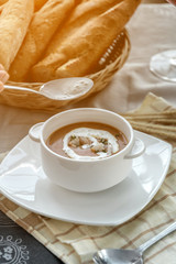 Vegetable cream soup with shrimps in bowl on table