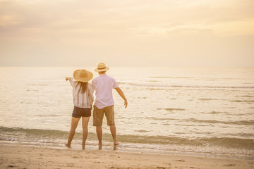 Couple walking on beach.