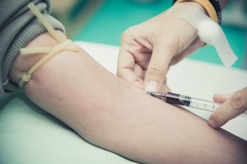 Close up of Blood collecting at arm. People and Healthcare concept. Hospital and clinic theme.