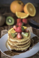 Buckwheat pancakes with berry fruit and honey.