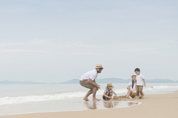 happy family with two kids on the beach,