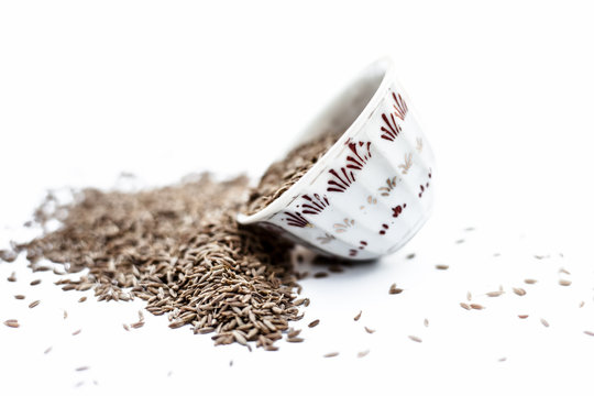 Common cumin or zeera or jeera in a bowl isolated on white.