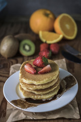 Buckwheat pancakes with berry fruit and honey.