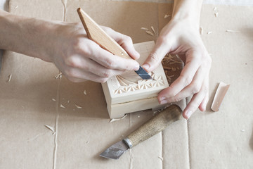 image of hands performing carving on wood