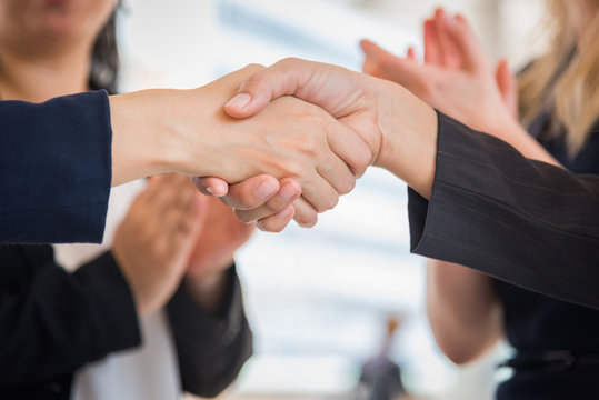Close up of Business people shaking hands after finish agreement for startup new project. Negotiating and Happy working concept. Handshake gesturing connection deal concept. People and teamwork theme