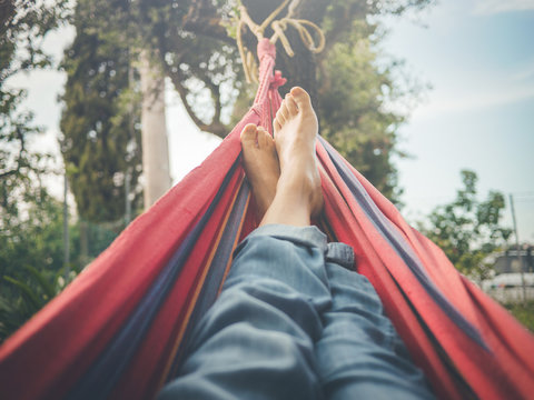 relaxing in the hammock, nude feet close up, spring day