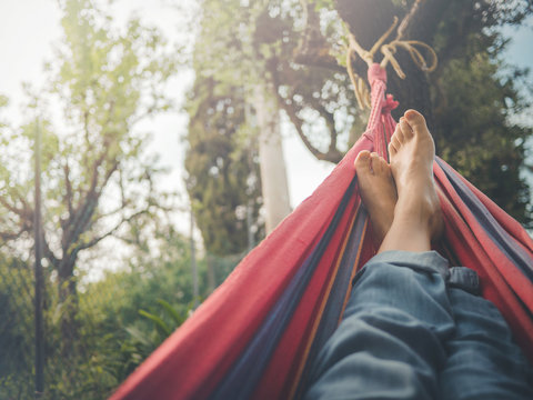 nude feet relaxing on hammock in spring season