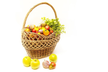 Summer harvest is in a wooden basket - vegetables and fruits on white background