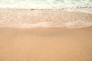 Fototapeta na wymiar Background soft wave of Sea with foam on sandy beach.