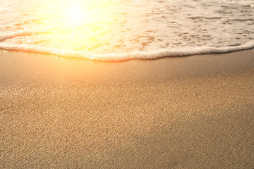 Background soft wave of Sea with foam on sandy beach.