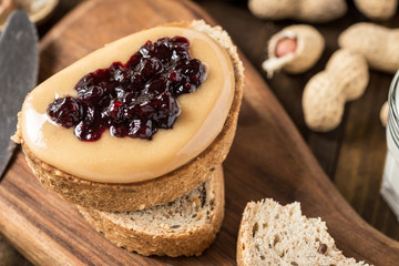 Homemade Healthy Breakfast. Peanut Butter and Jelly on Dark Wooden Background.